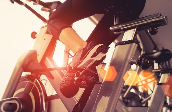 Exercise bike cardio workout at fitness gym of woman taking weight loss with machine aerobic for slim and firm healthy in the morning. Exercise bike cardio workout at fitness gym of woman taking weight loss with machine aerobic for slim and firm healthy in the morning.