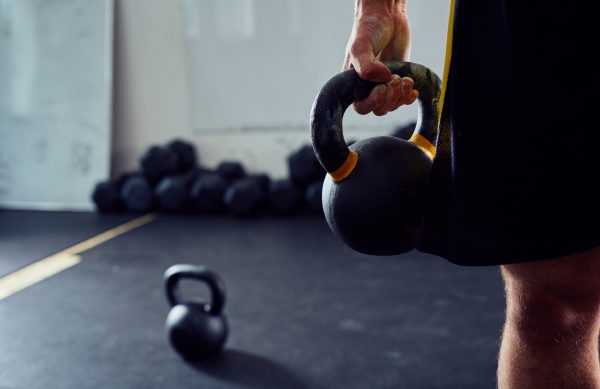 Closeup of kettlebell held by athlete at the gym